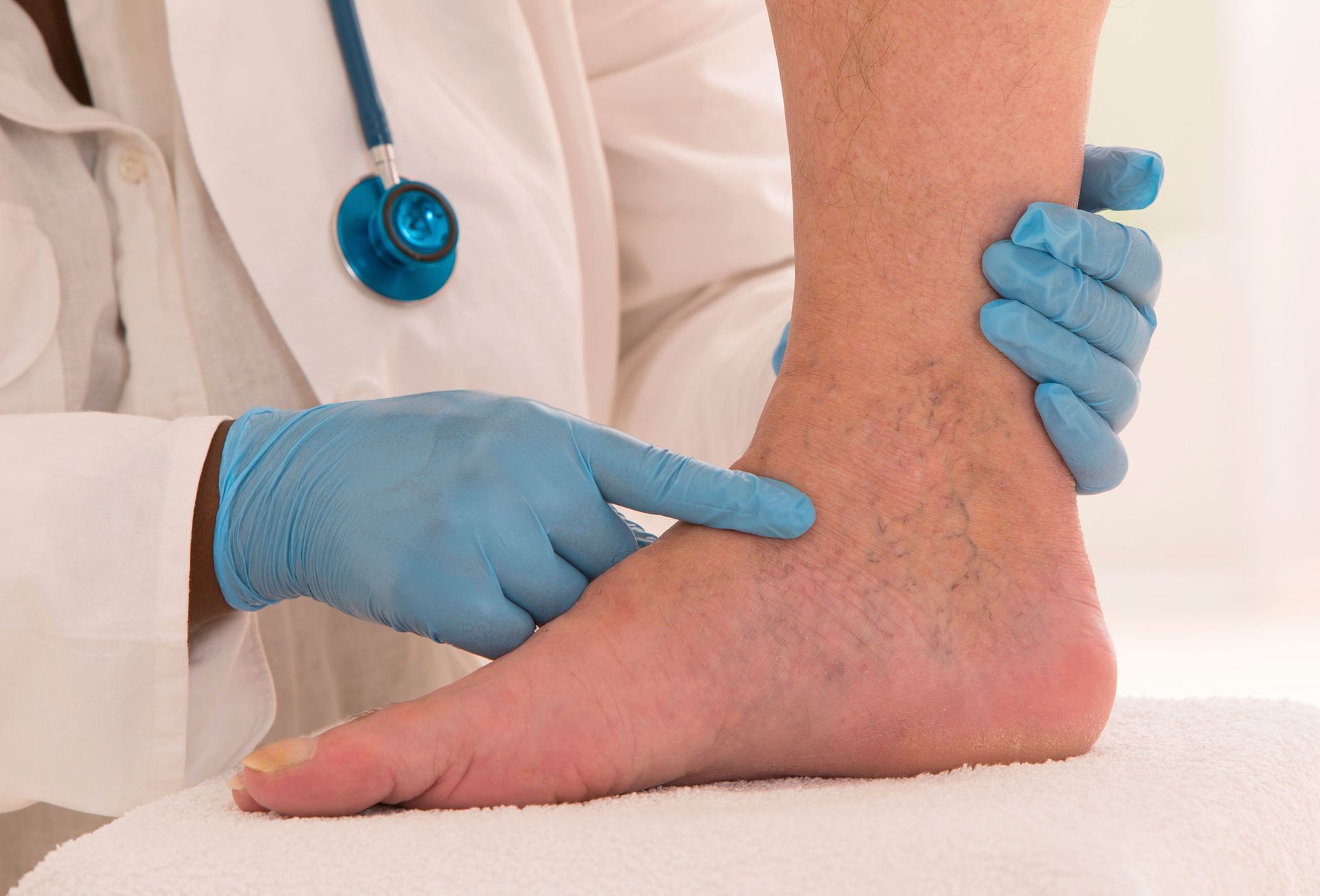 A doctor is examining a patient's leg with varicose veins.