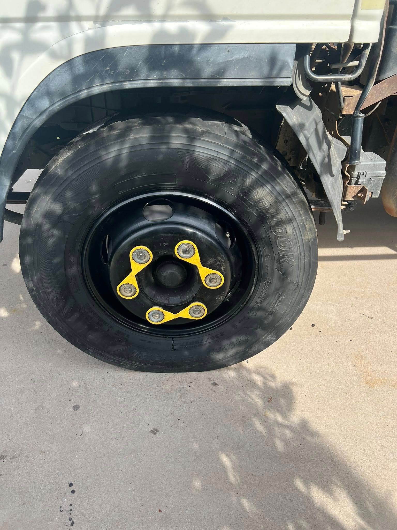 Black Truck Tire With Yellow Accents; Flat Against Concrete — North Coast Heavy Diesel In Coffs Harbour, NSW