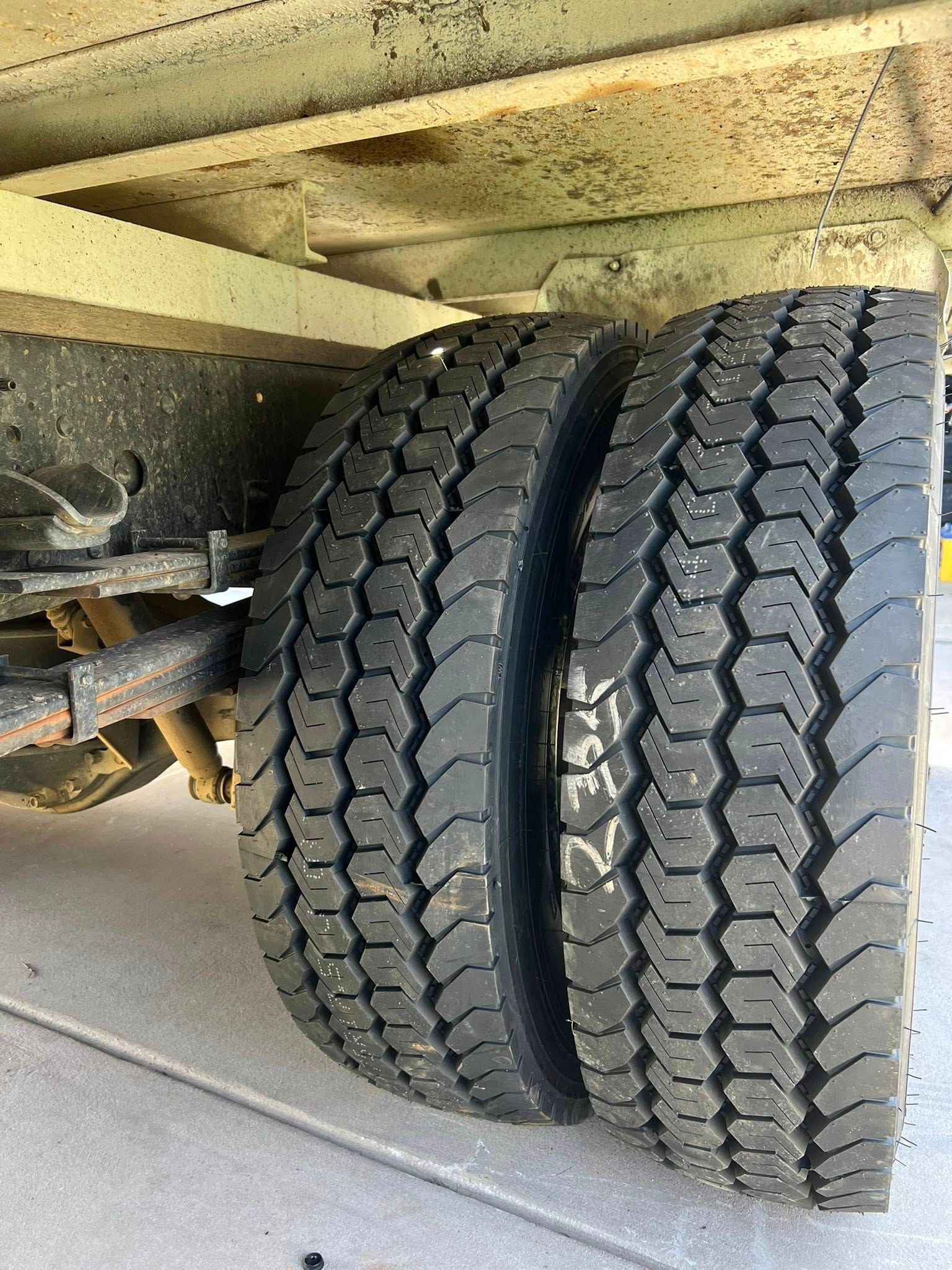 Two Black Truck Tires Mounted on a Yellow Trailer, on a Concrete Surface — North Coast Heavy Diesel In Thrumster, NSW