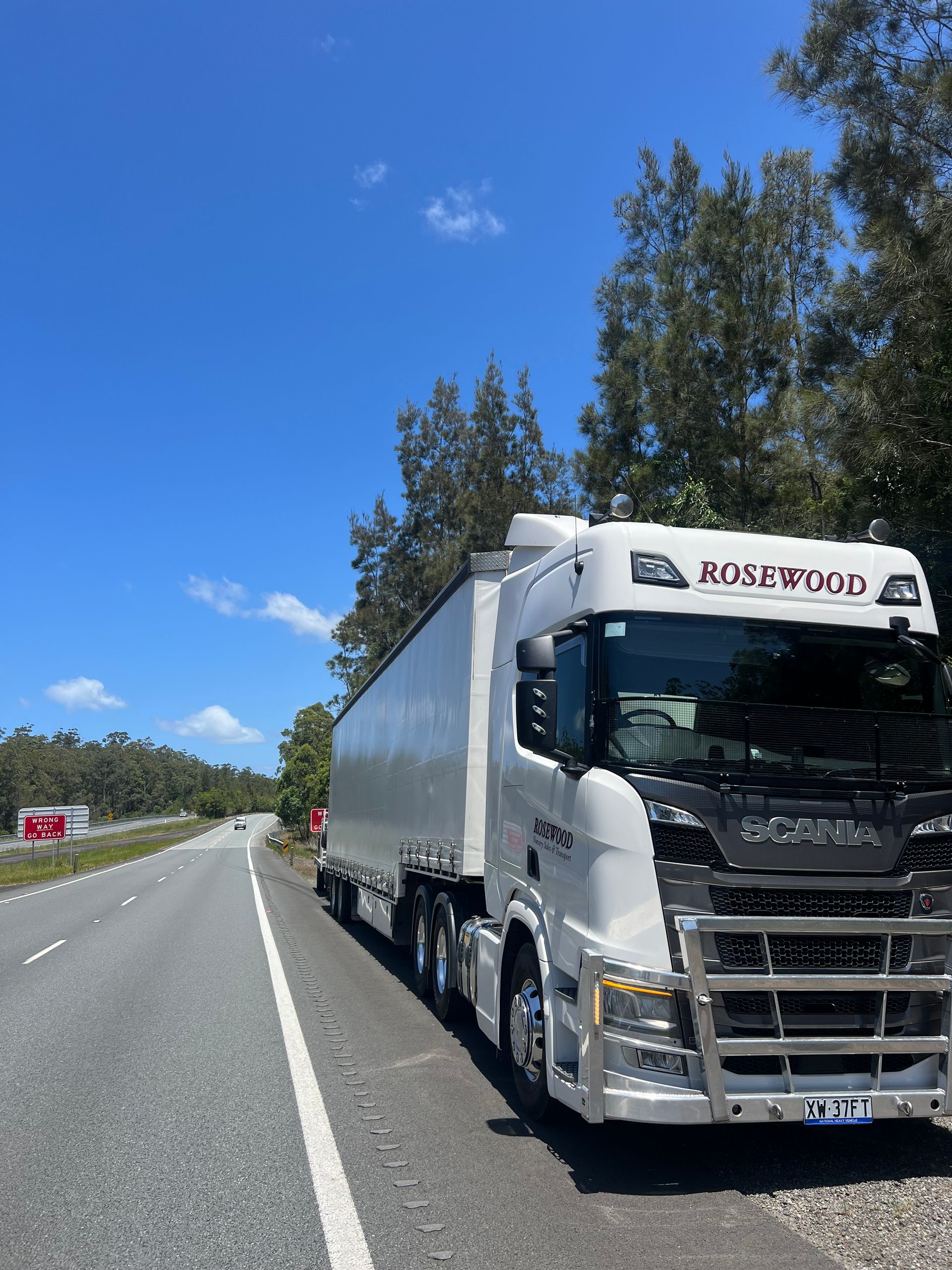 White Semi-truck Parked on the Side of a Highway on a Sunny Day — North Coast Heavy Diesel In Kempsey, NSW
