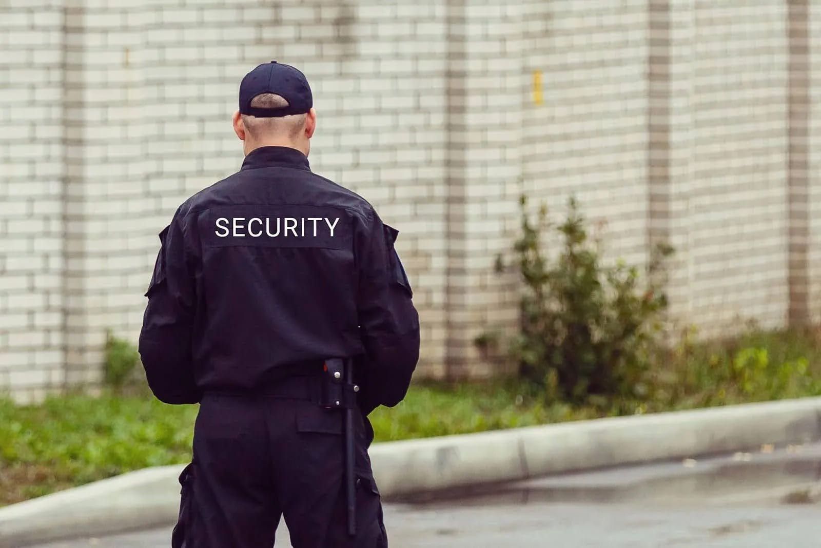 a security guard next to a building