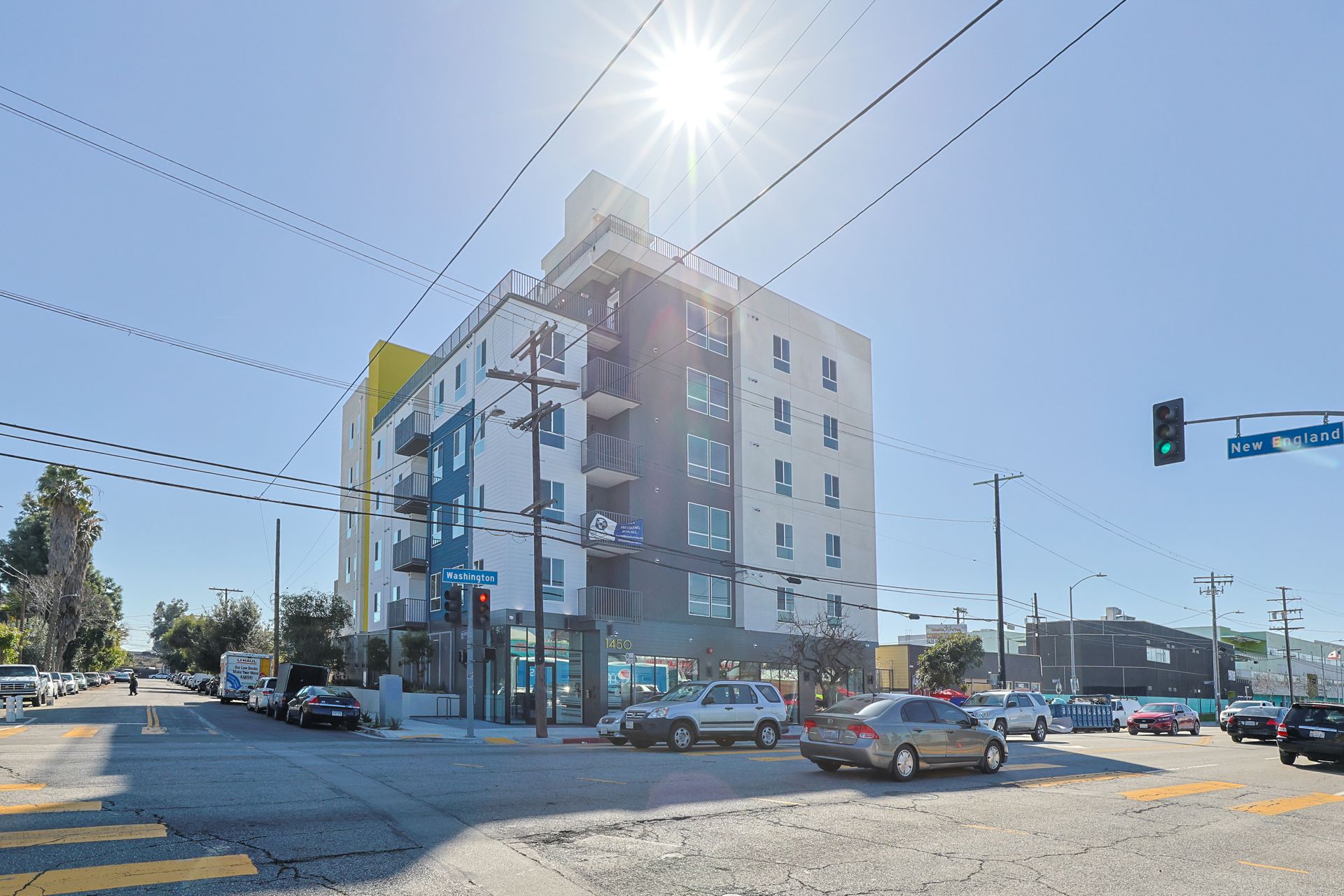 A large building is sitting on the corner of a city street.
