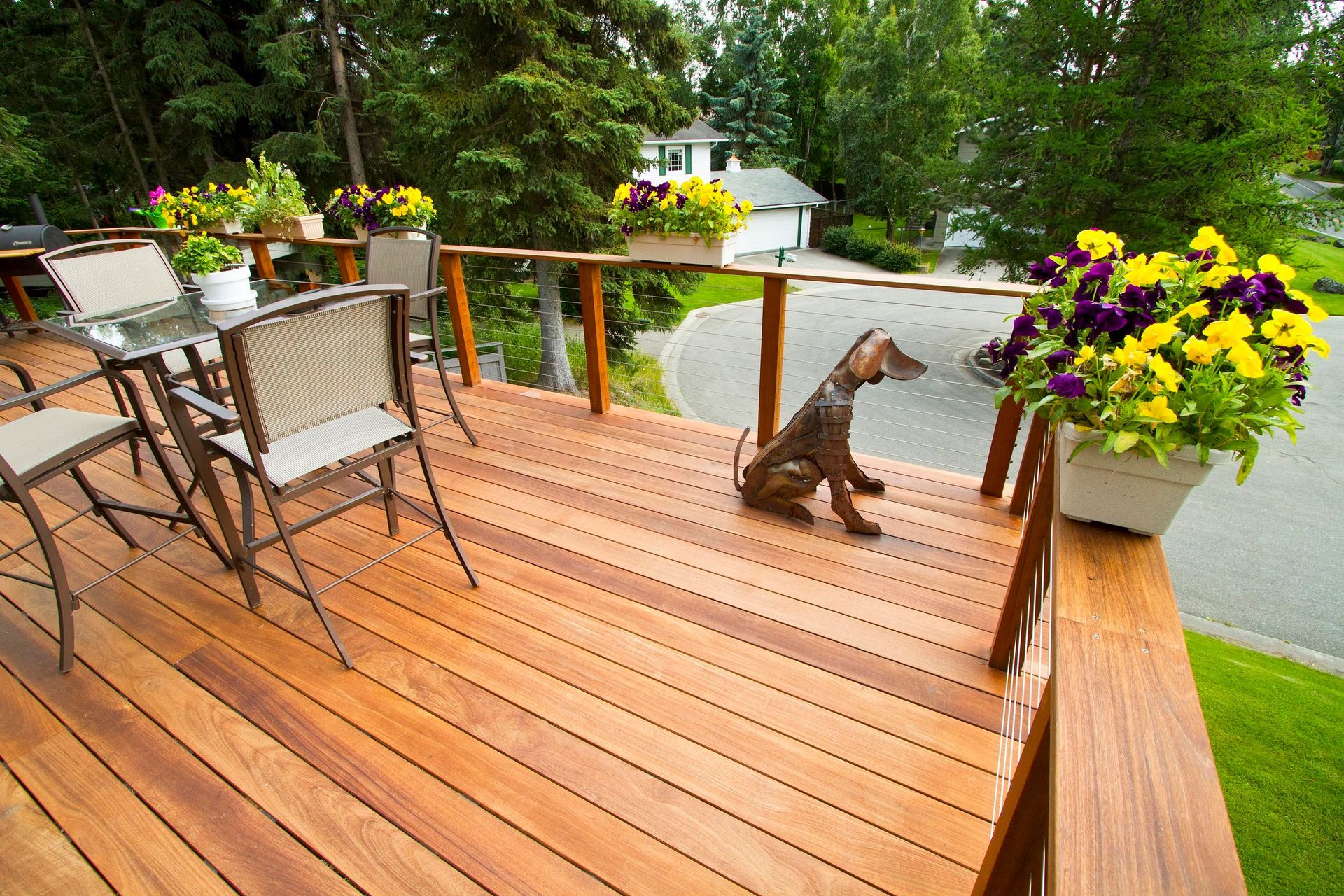 A wooden deck with a statue of a dog on it