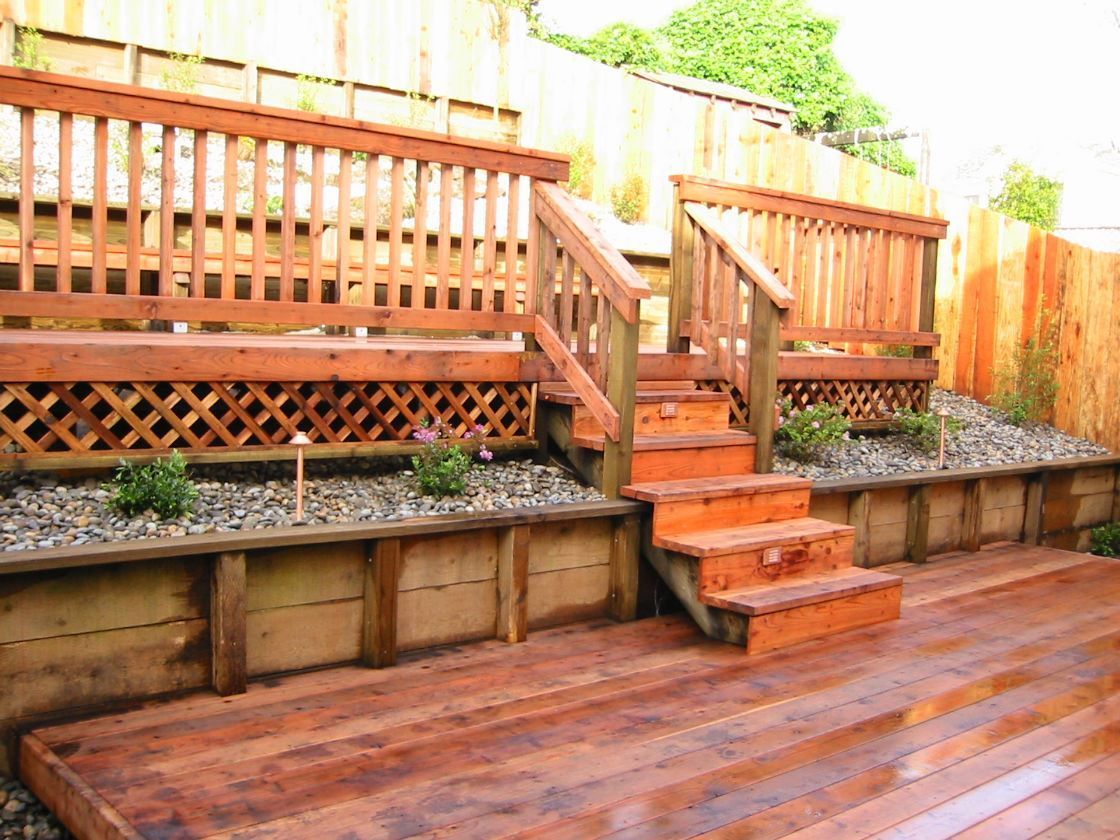 A wooden deck with stairs leading up to it