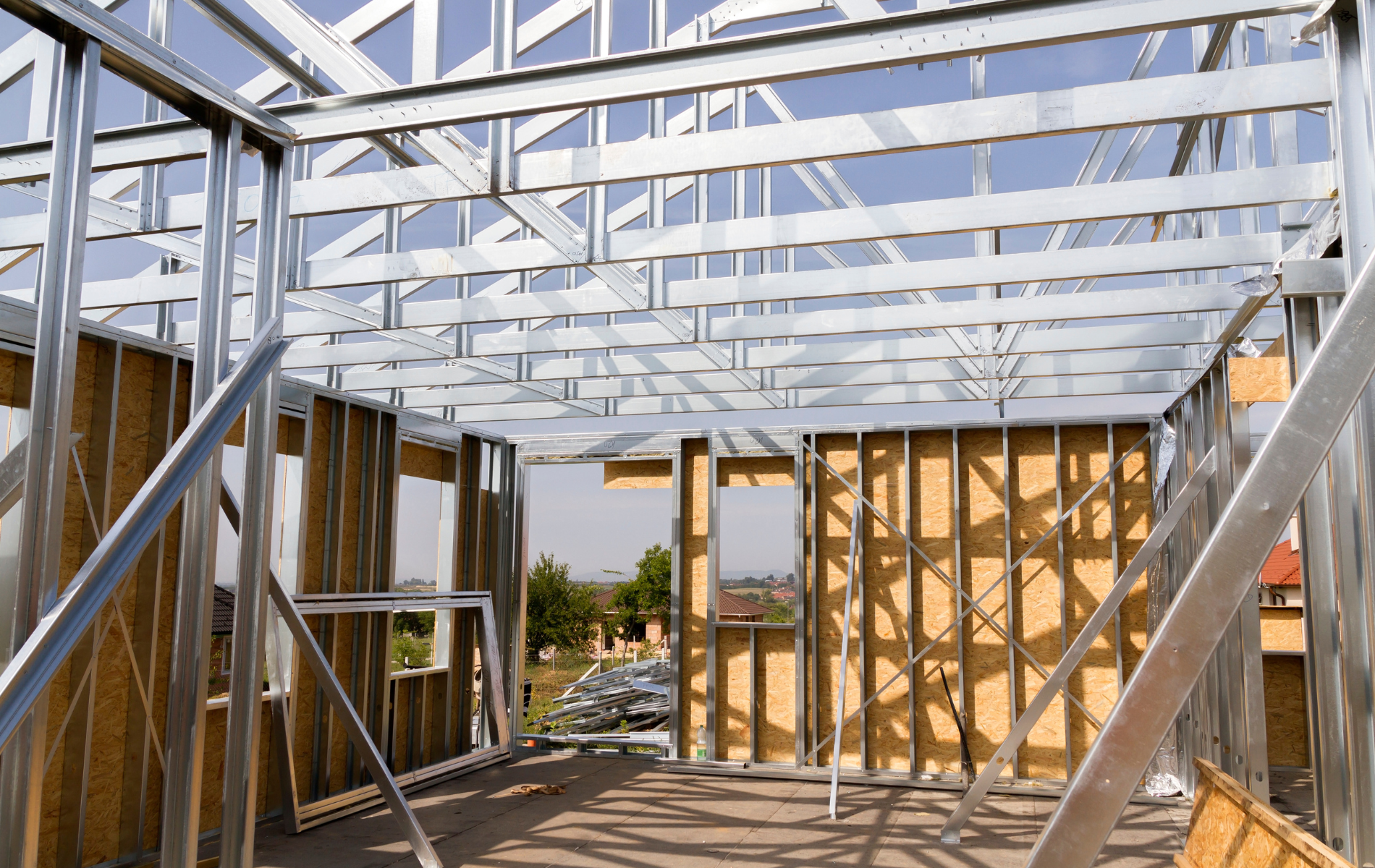 The inside of a house under construction with a metal frame.