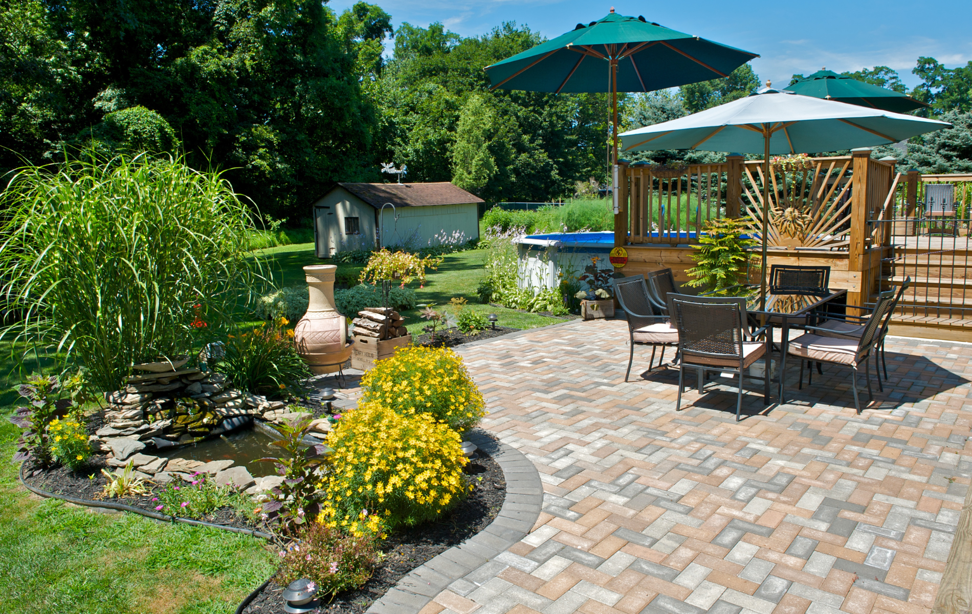 A patio with a table and chairs and umbrellas