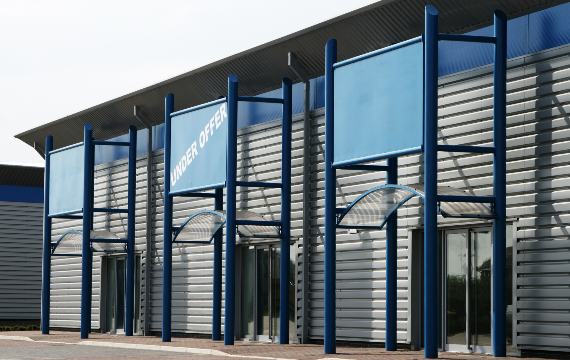 A building with a blue sign that says ' visitor center ' on it