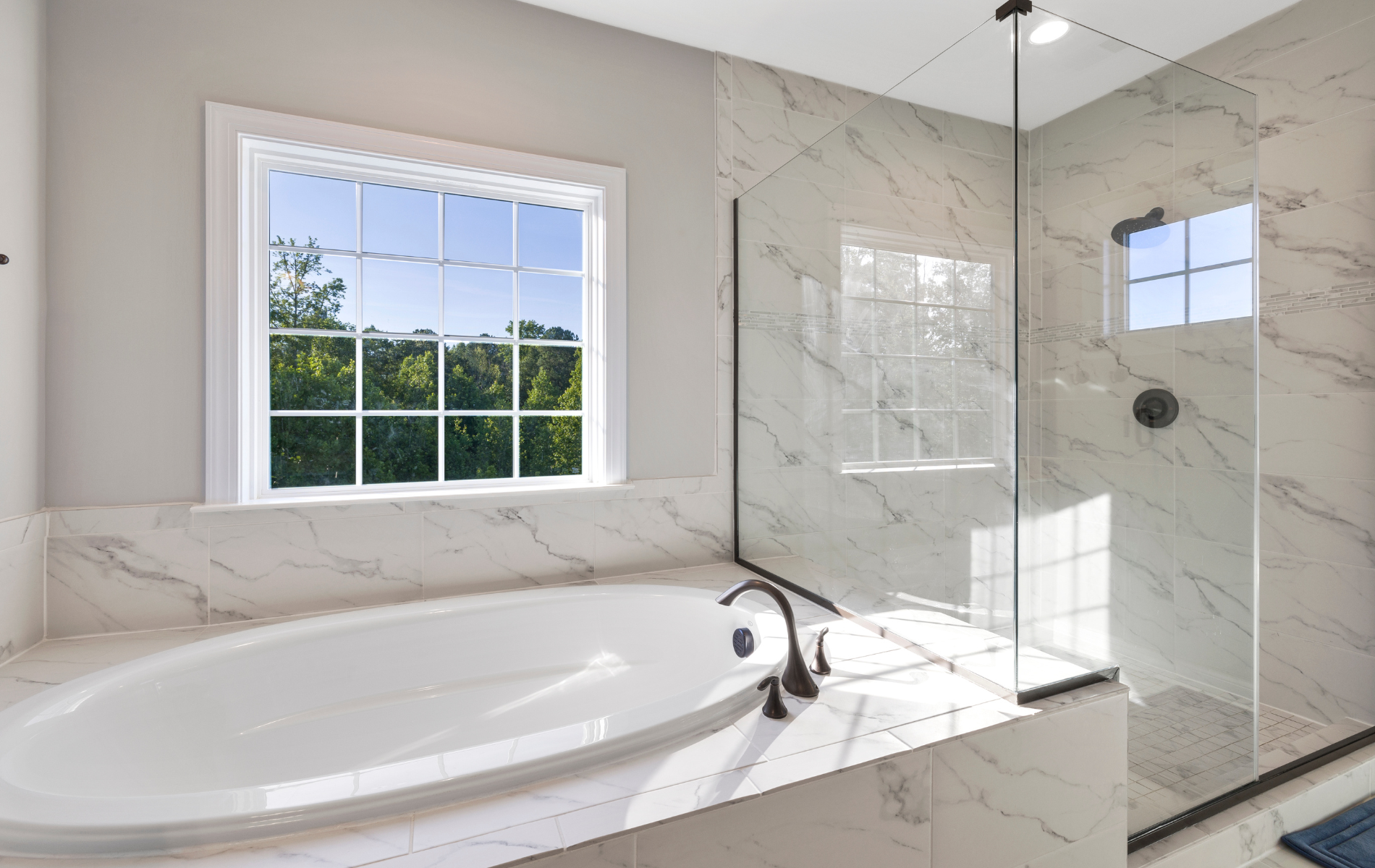 A bathroom with a tub , shower and window.