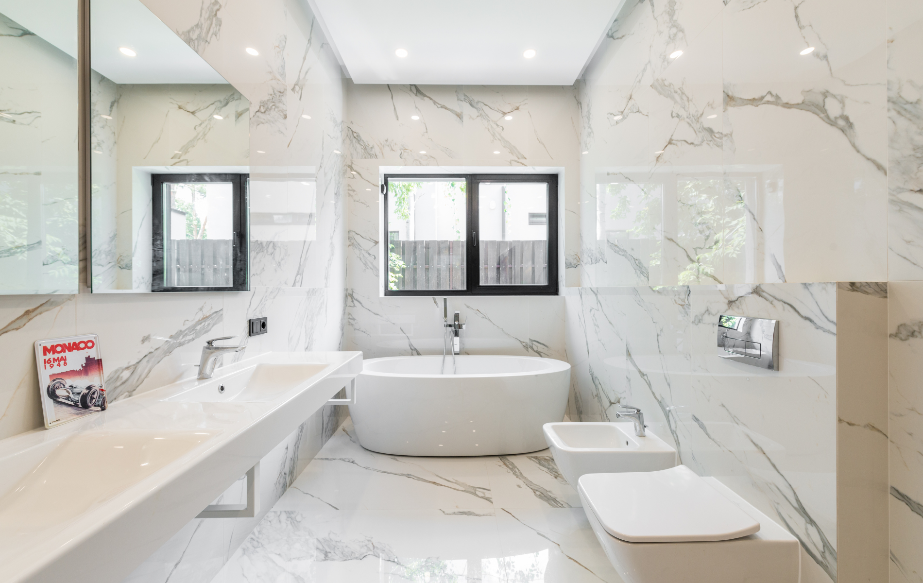 A bathroom with a bathtub , sink , toilet and bidet.