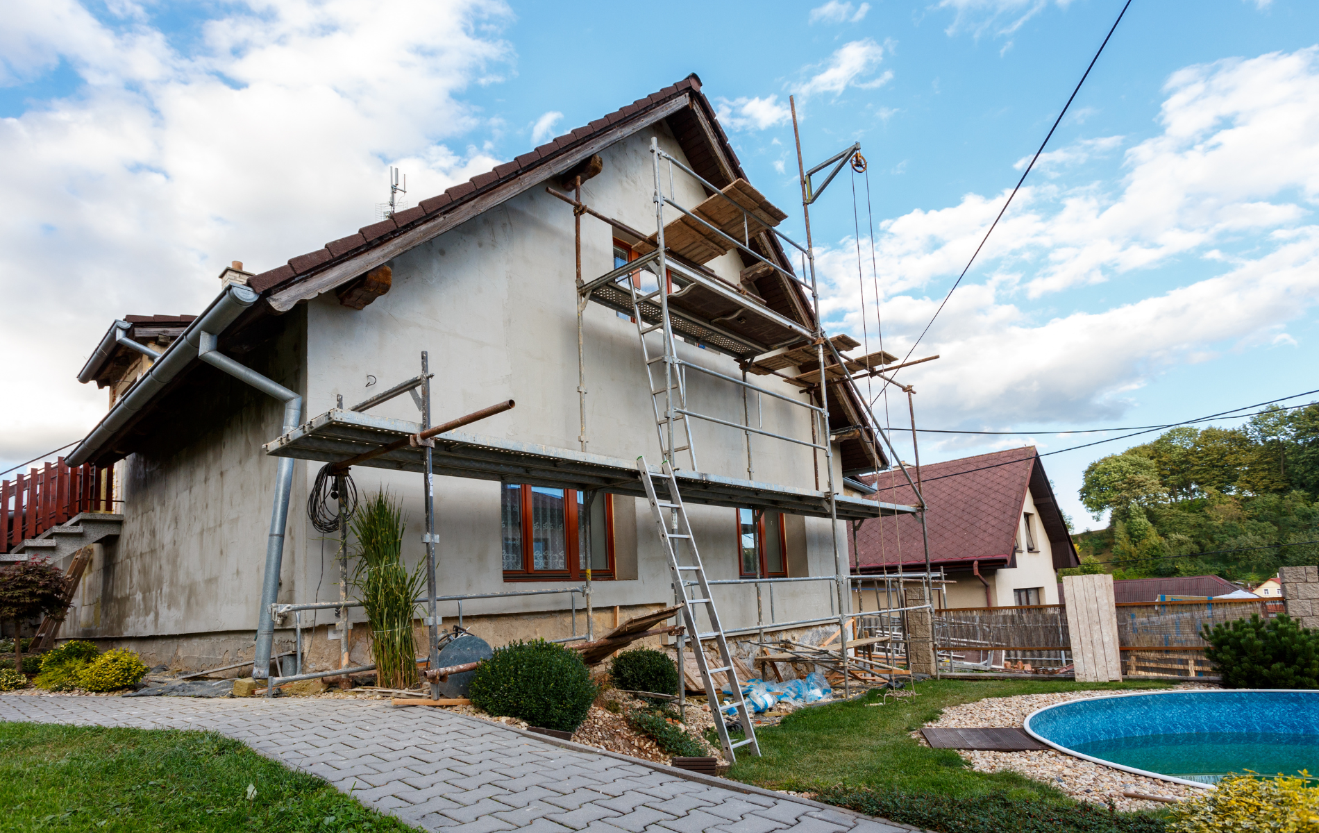 A house is being painted with scaffolding in front of it.