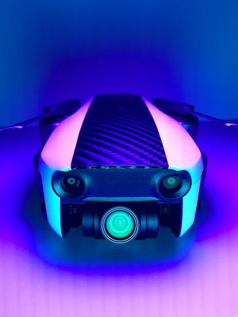 Drone with a camera, illuminated in blue and pink light.