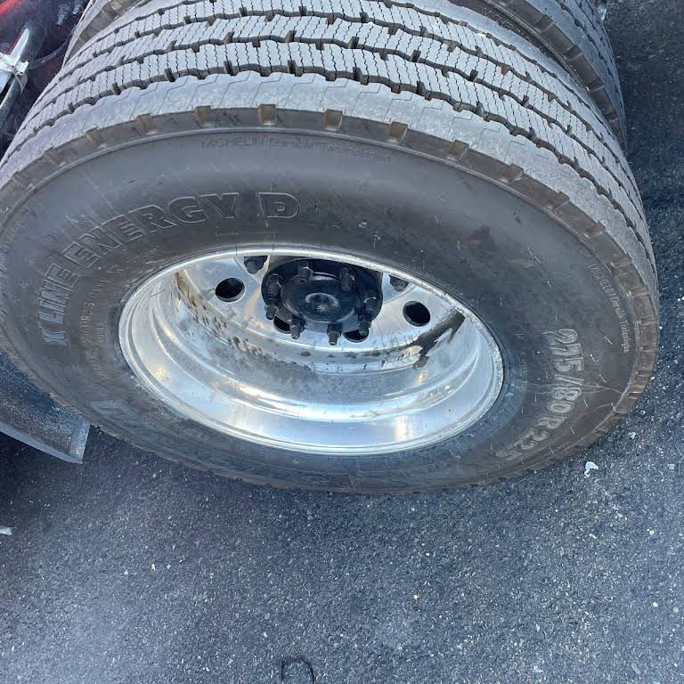 a close up of a truck tire on the ground .