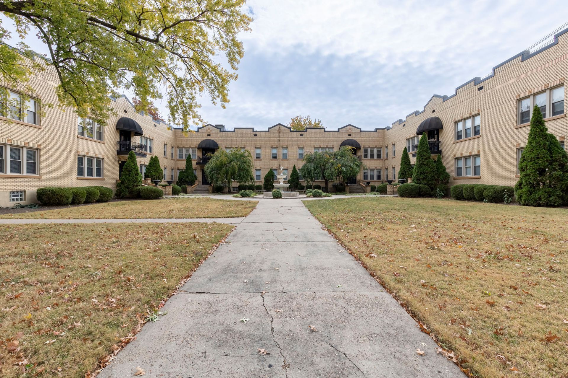 A large building with a concrete walkway leading to it.