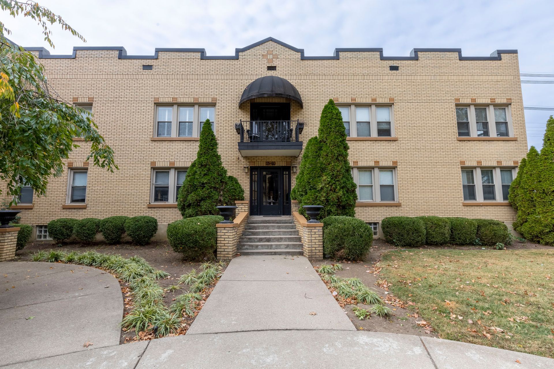 A large brick building with a walkway leading to it