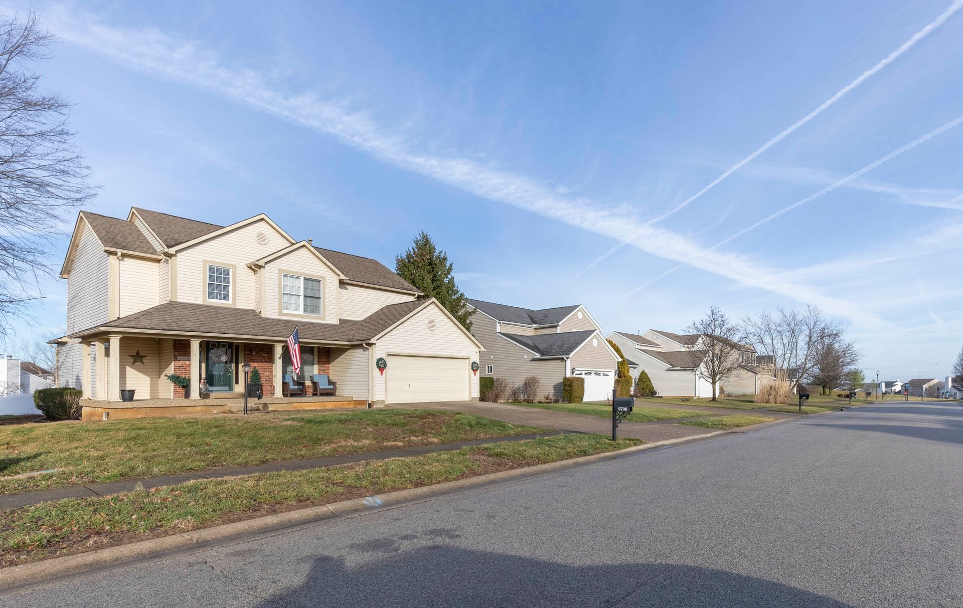 a row of houses on a sunny day in a residential neighborhood .