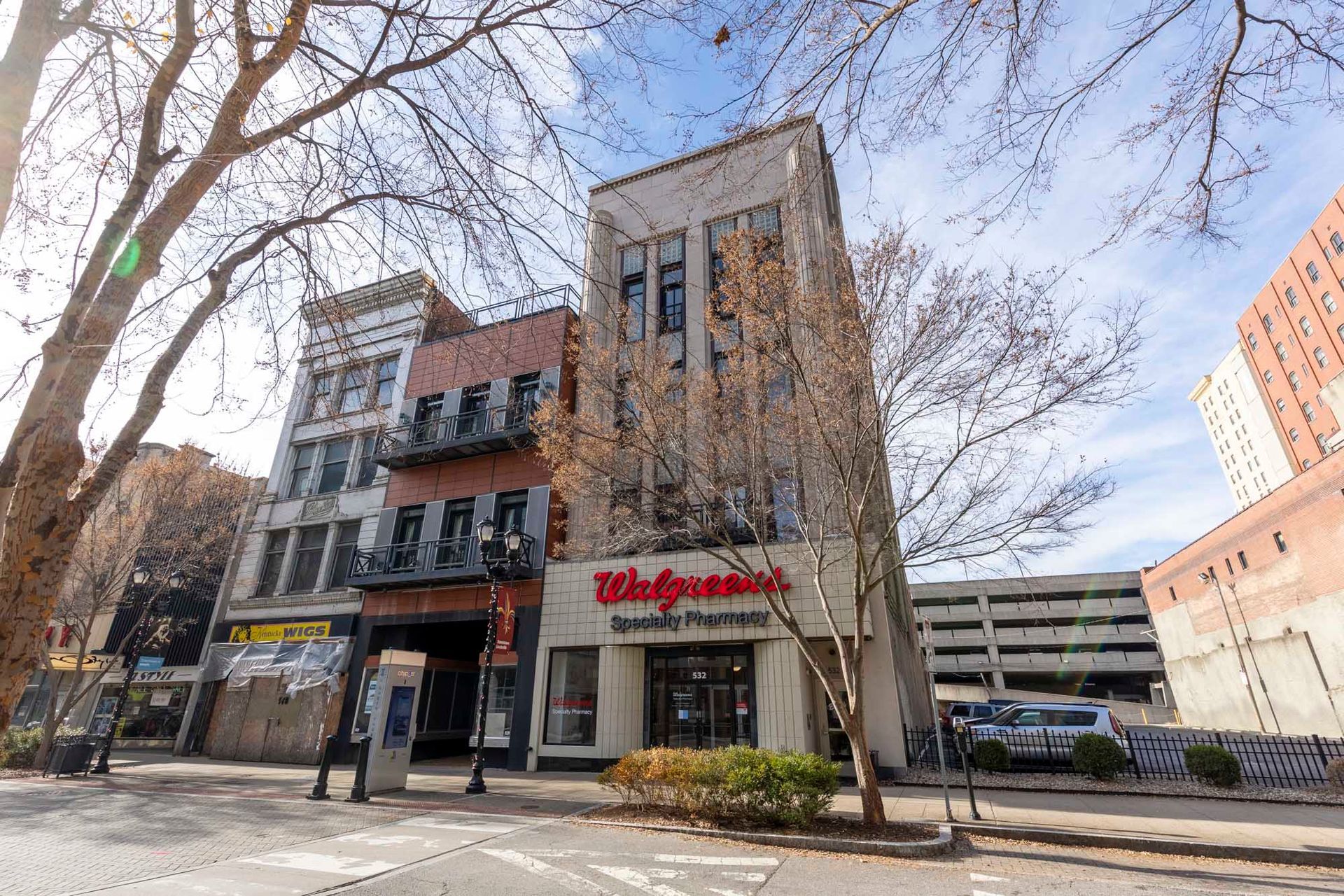 a large building with a walgreens store in front of it .