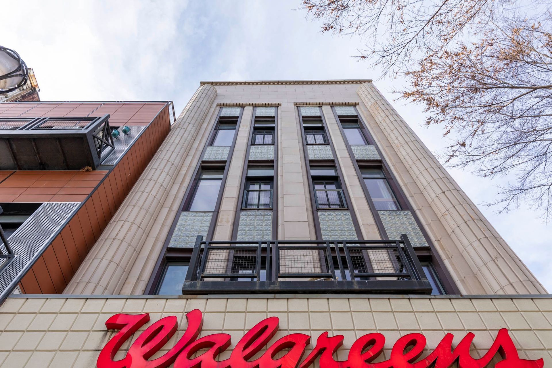 looking up at a walgreens store in a city