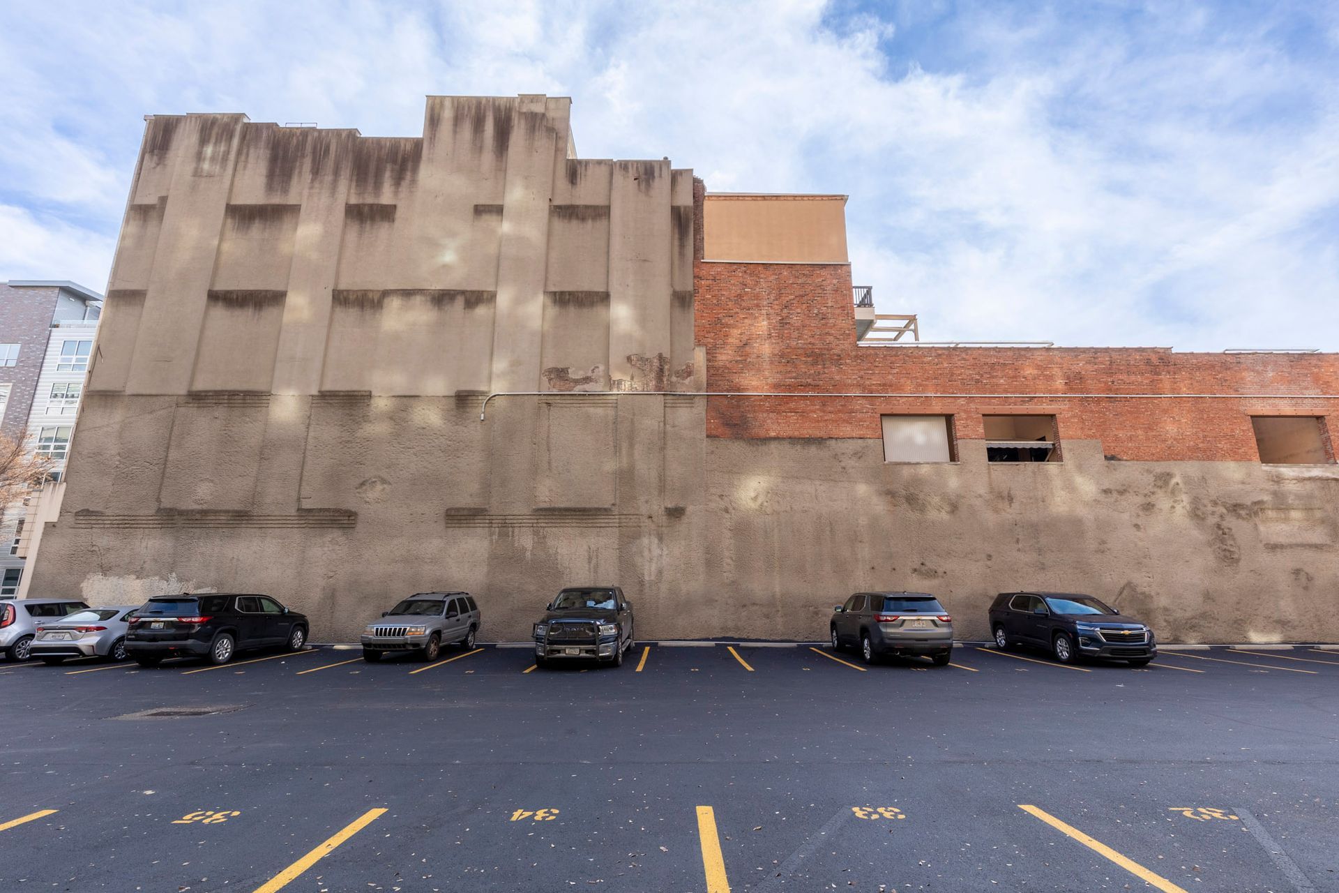 a parking lot with cars parked in front of a building