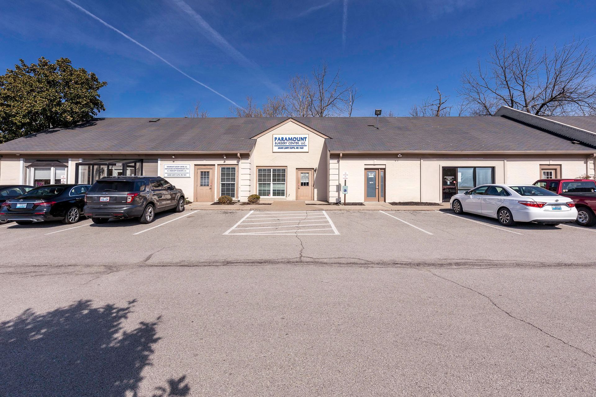 A building with a lot of cars parked in front of it