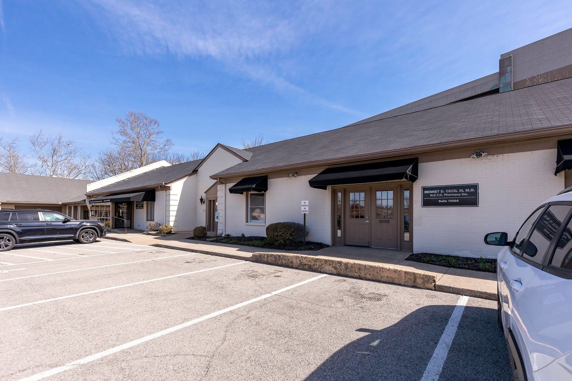 A building with a lot of cars parked in front of it