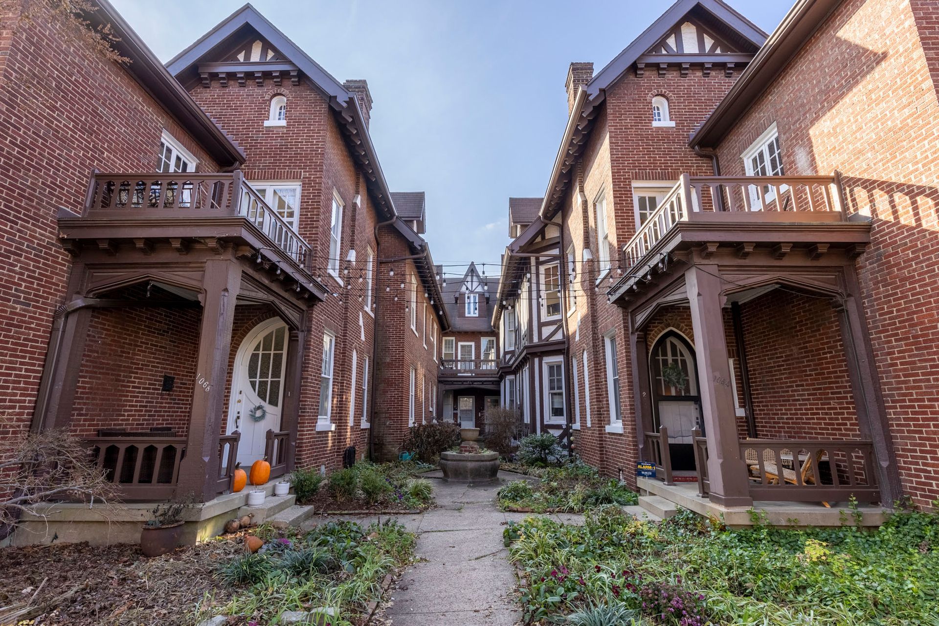 a row of brick houses with porches are lined up next to each other