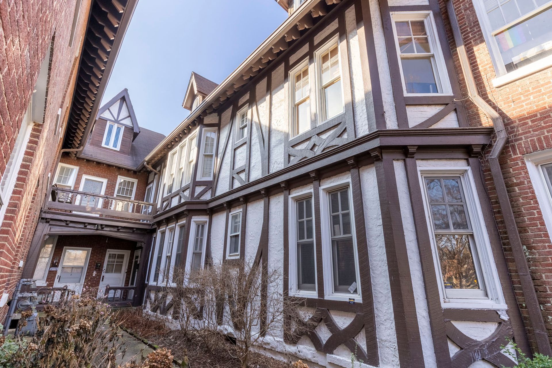 a large brick building with a lot of windows and a wooden frame .