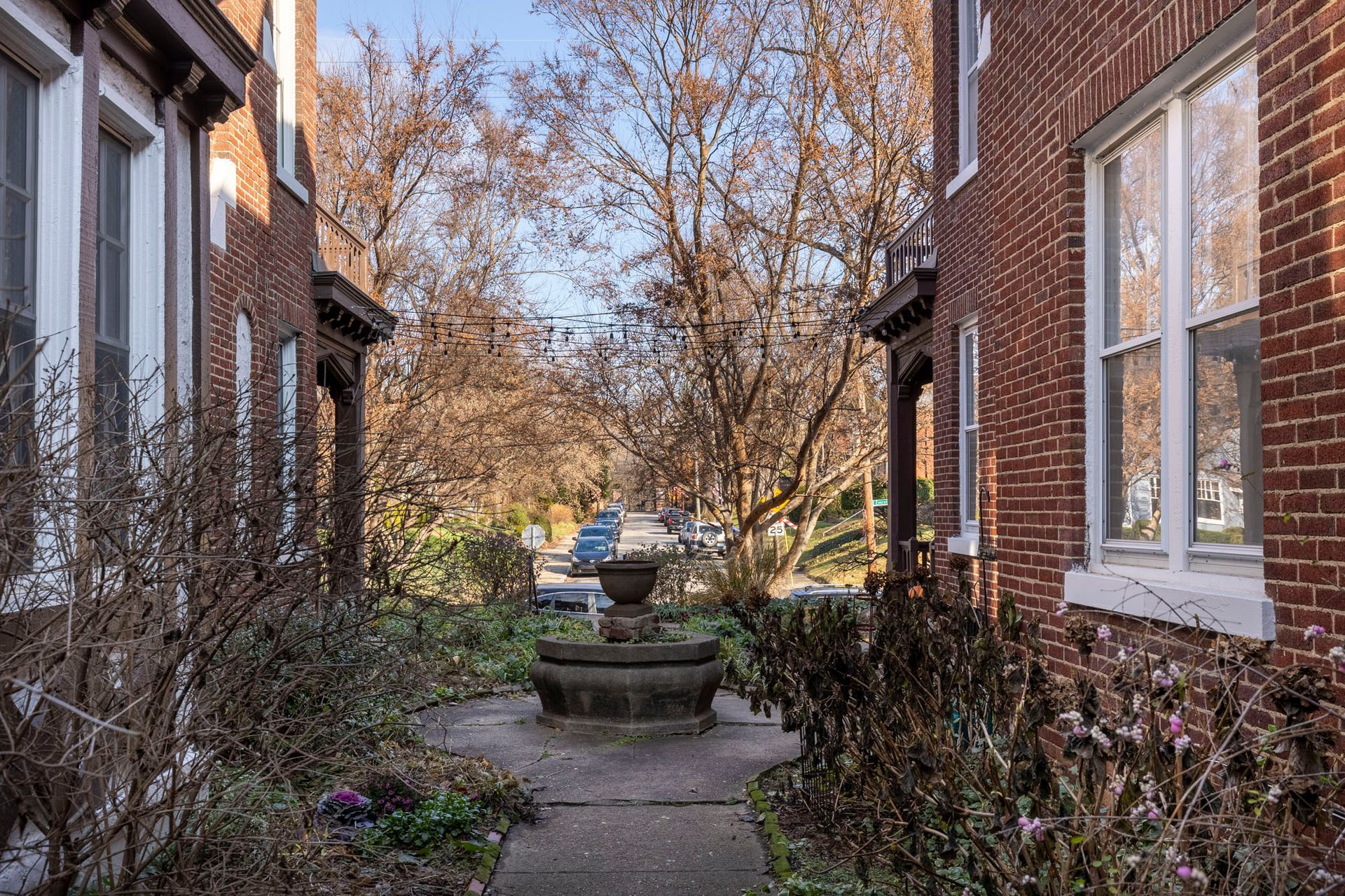 a brick building with a fountain in the middle of it .
