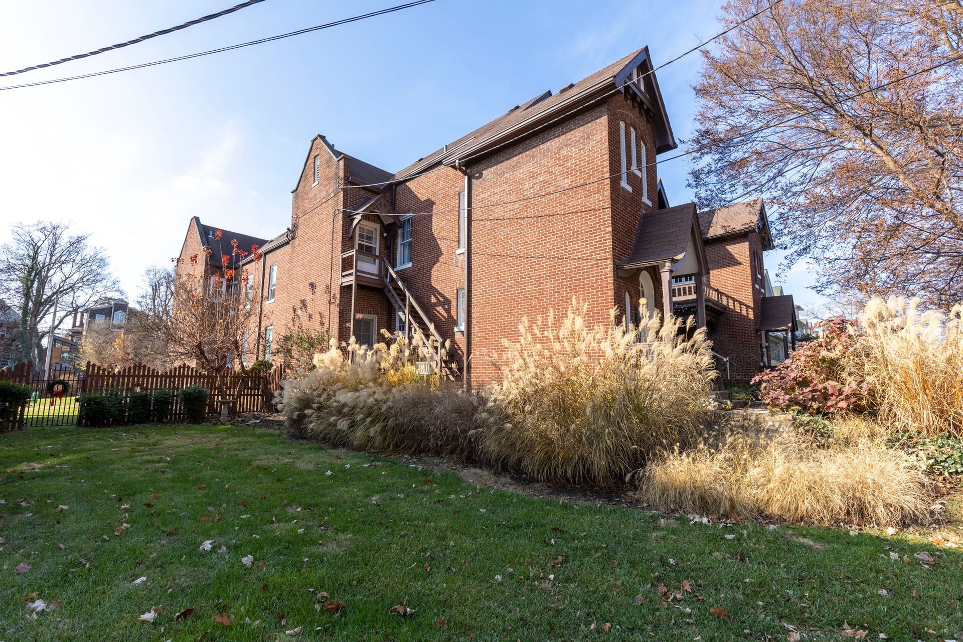 a large brick building with a lot of grass in front of it .