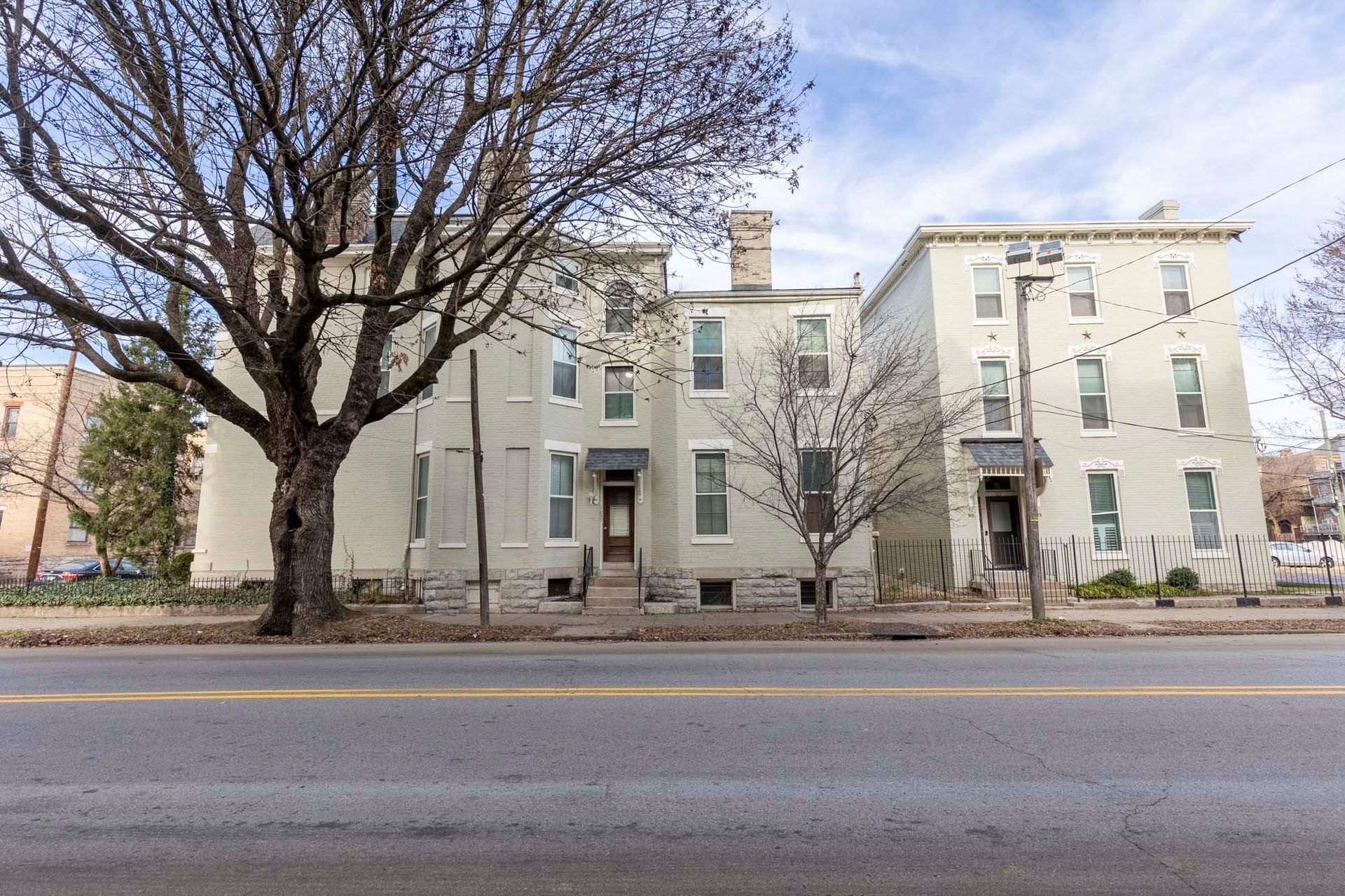 A large white building with a tree in front of it