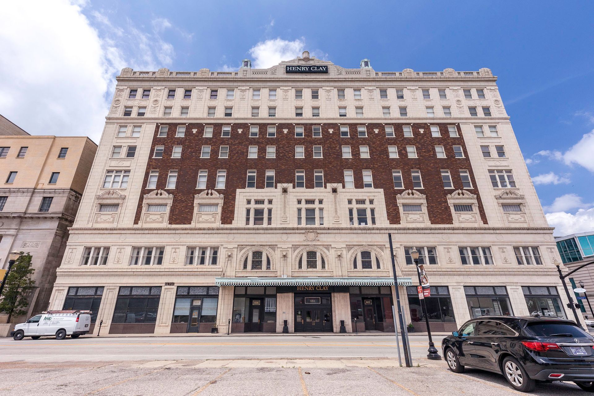A large building with cars parked in front of it.