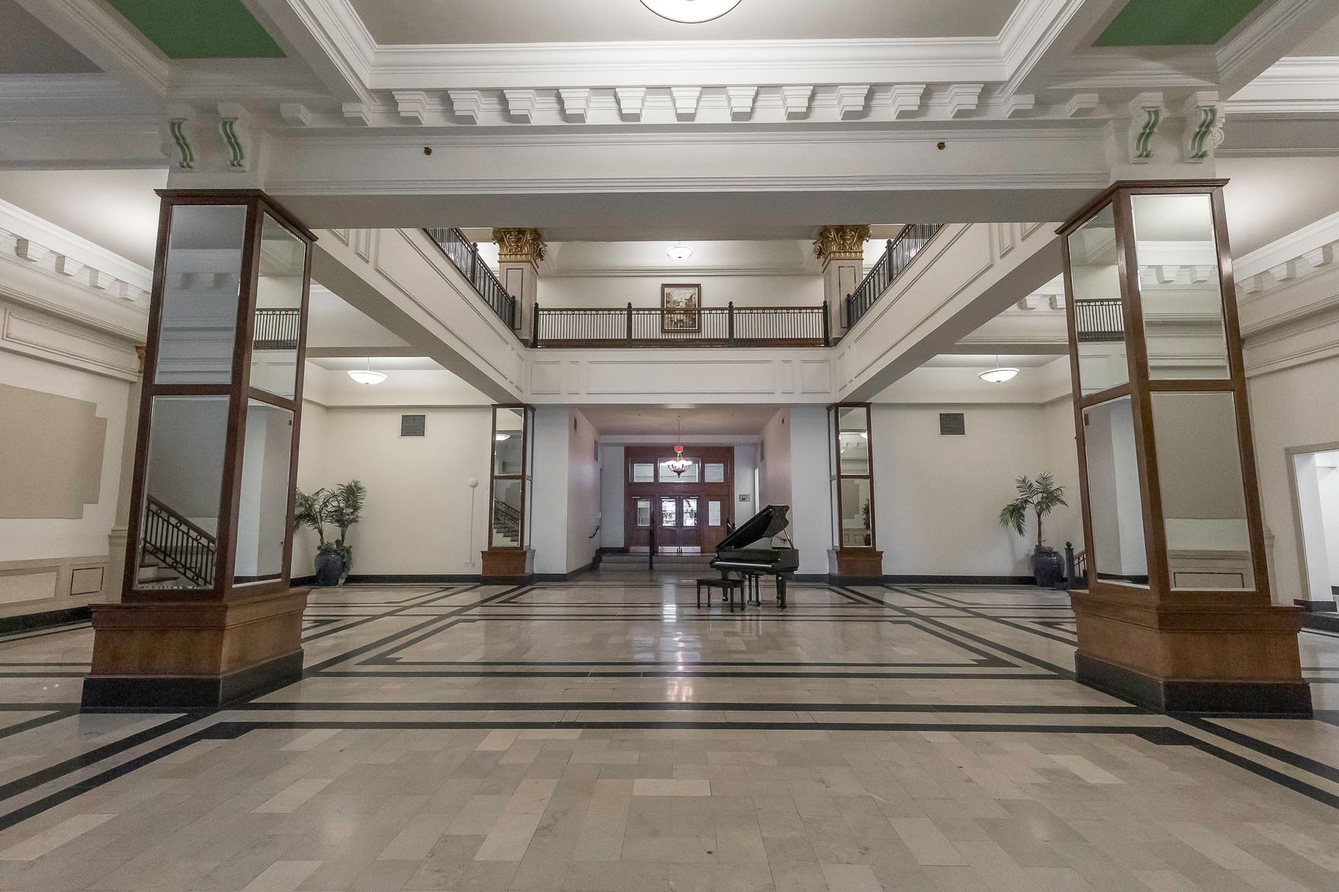 A large hallway with a piano in the middle of it