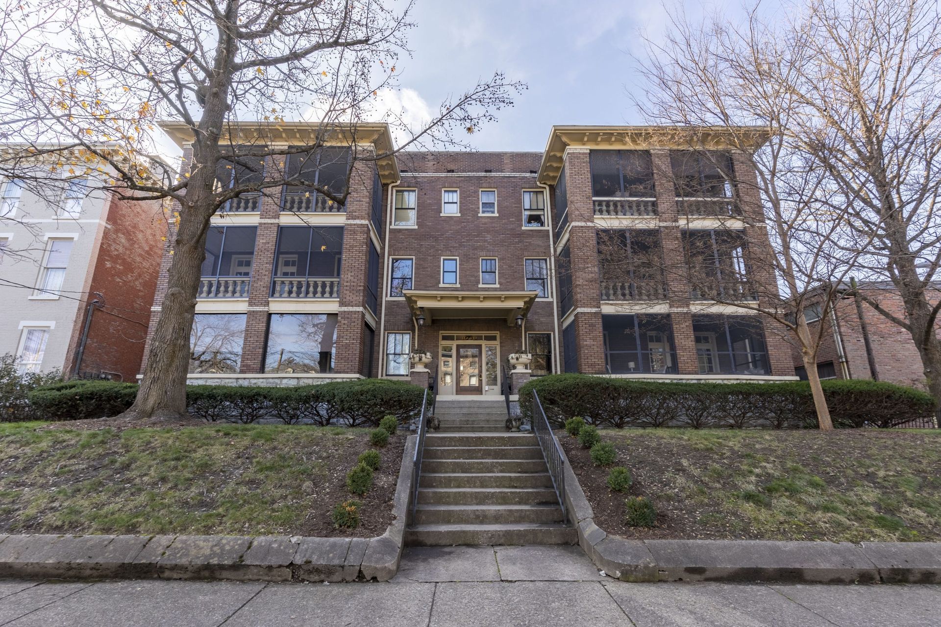 a large brick apartment building with stairs leading up to it