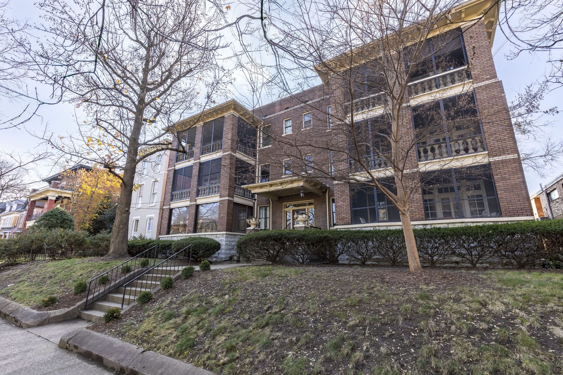 a large brick apartment building with stairs leading up to it .