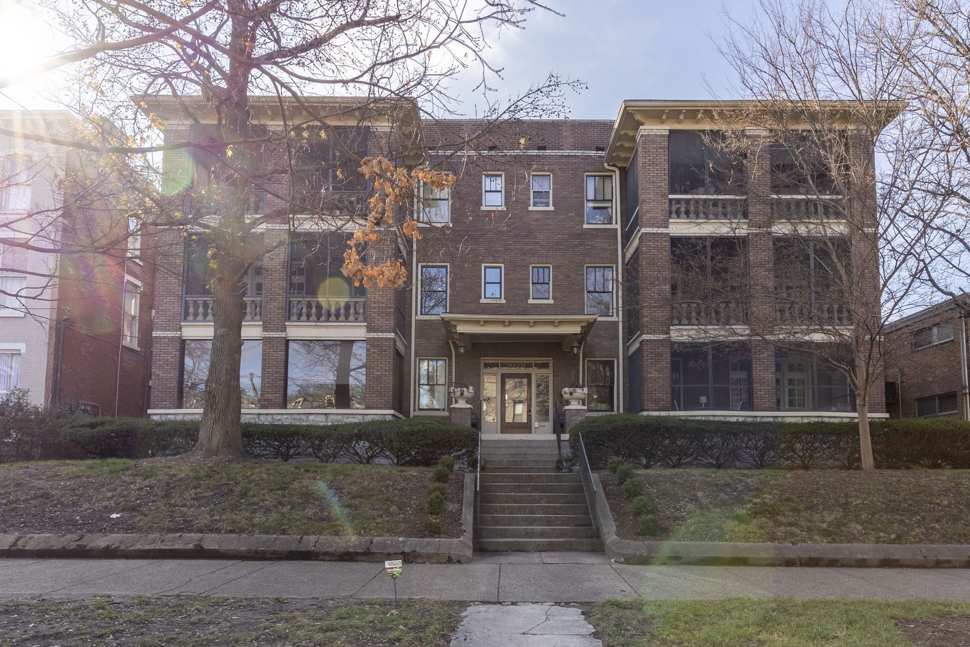 a large brick apartment building with stairs leading up to it