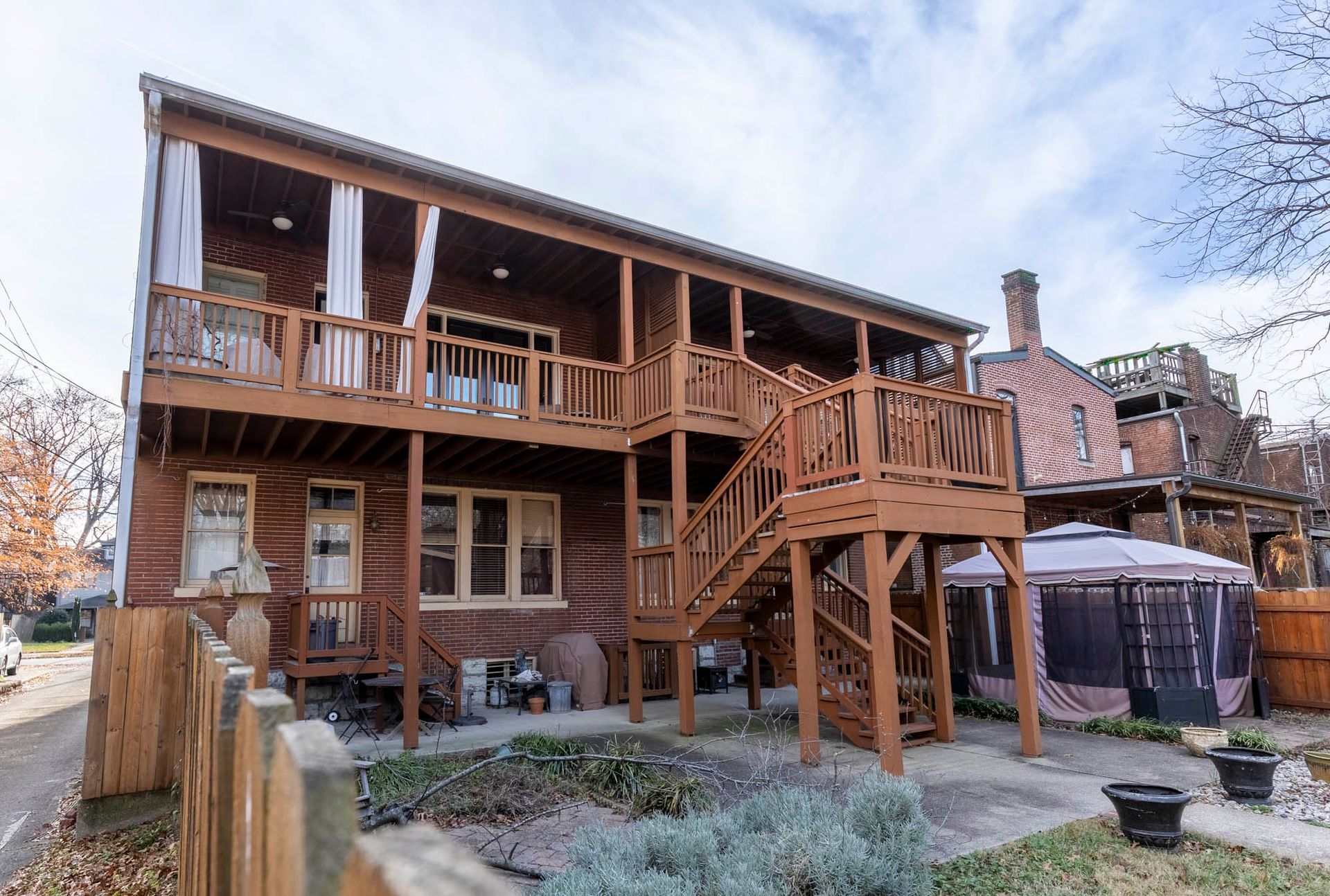 a large wooden house with a large deck and stairs .