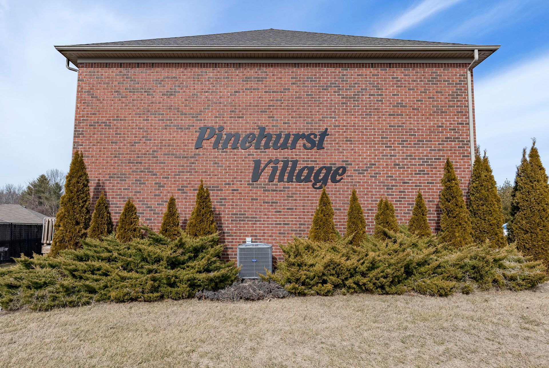 A brick building with pineburst village written on it