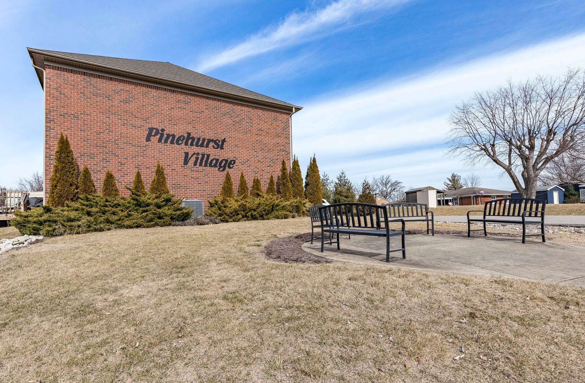 A brick building with a sign that says pinehurst village