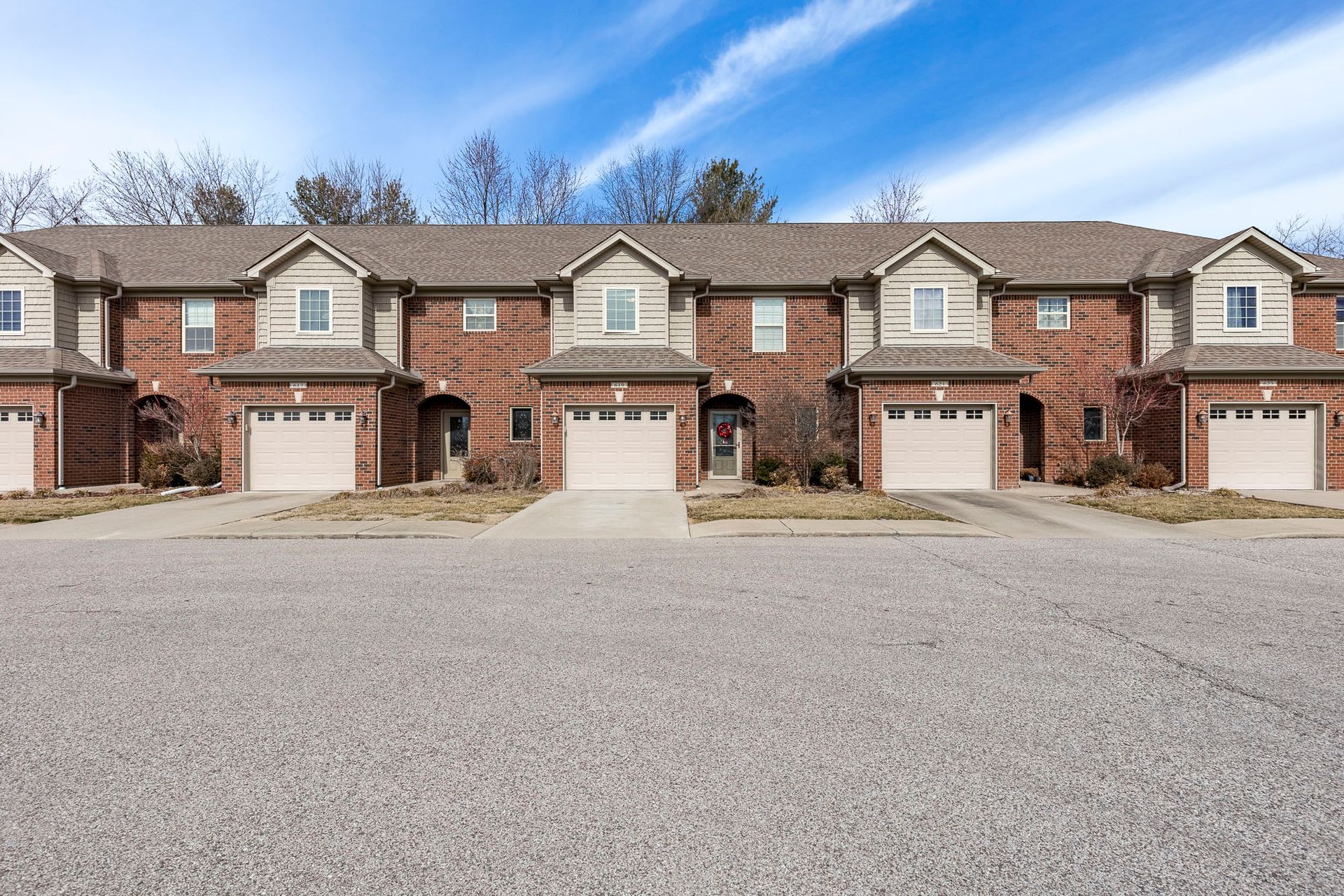 A row of brick houses with white garage doors