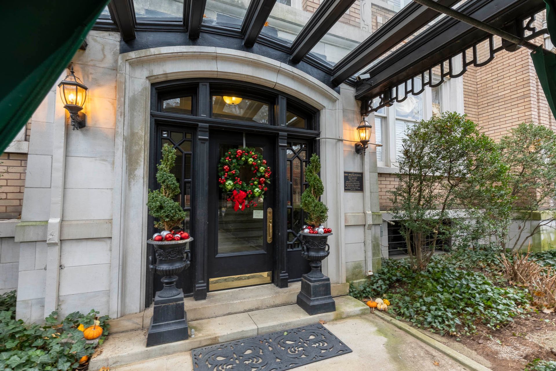 the front door of a building with a christmas wreath on it .