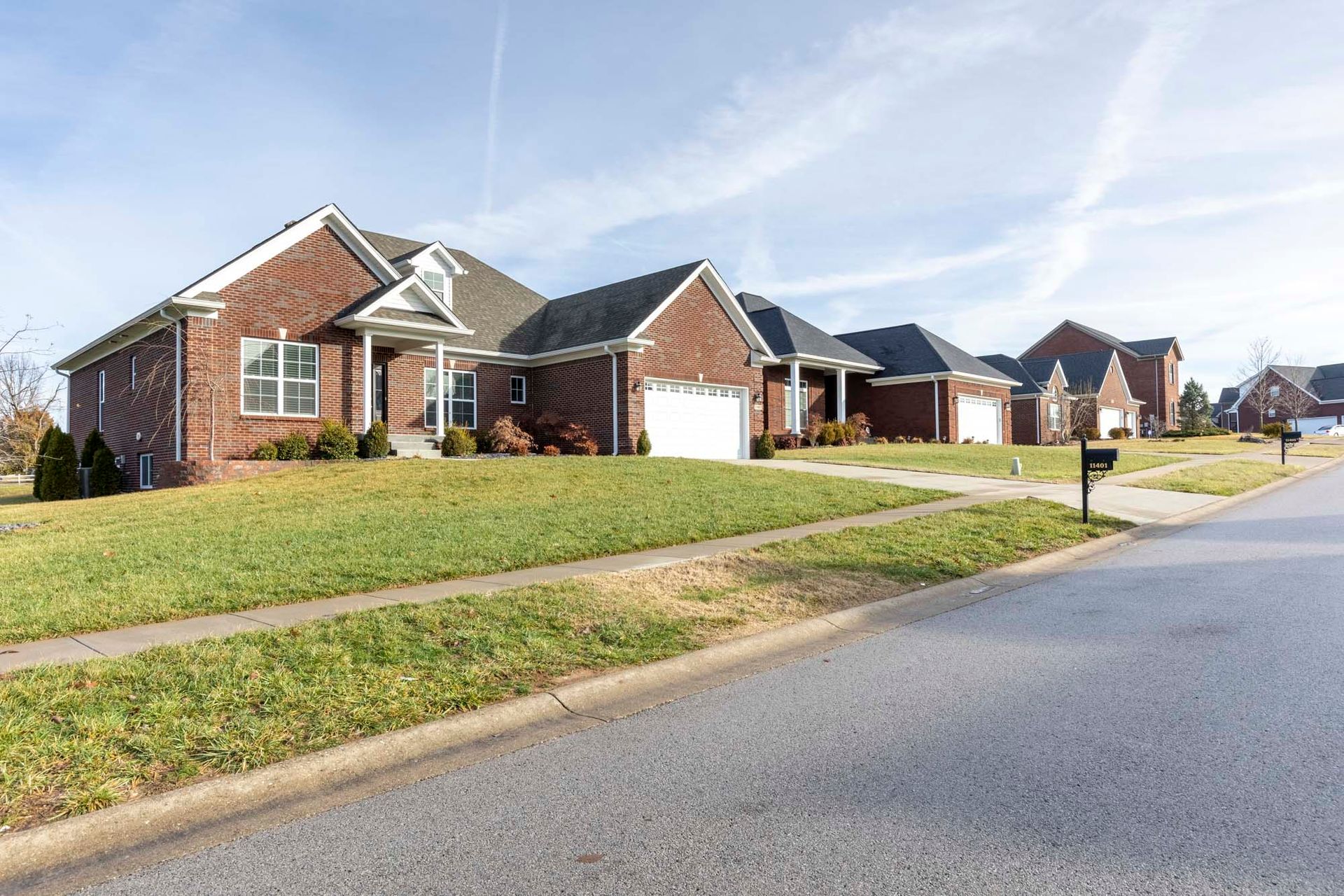 a row of houses in a residential neighborhood with a mailbox on the side of the road .