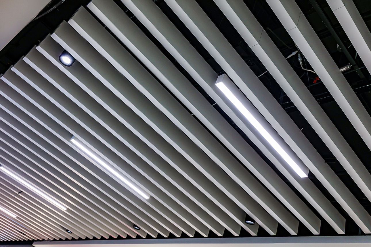 Metal grid ceiling with recessed lighting.