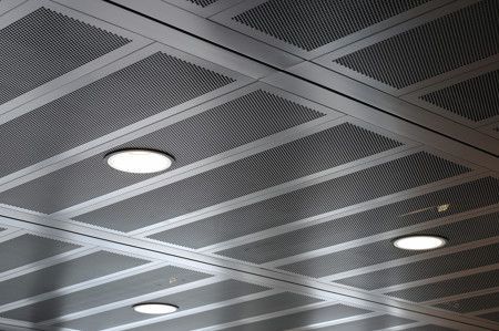 Metal grid ceiling with recessed lighting.