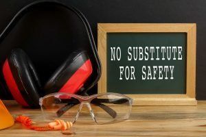 A sign that says `` no substitute for safety '' is on a wooden table.