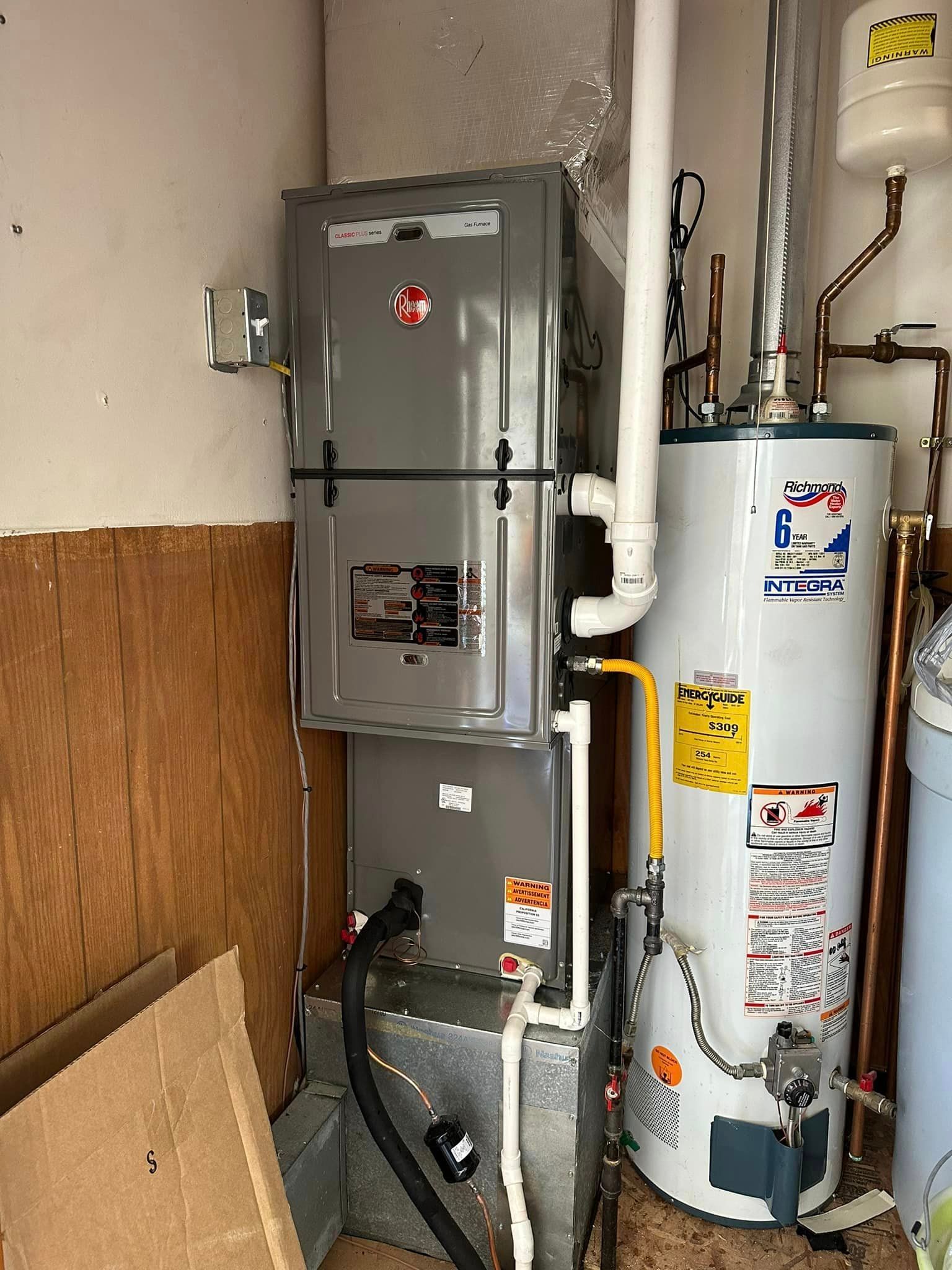 A room with a water heater and a furnace.