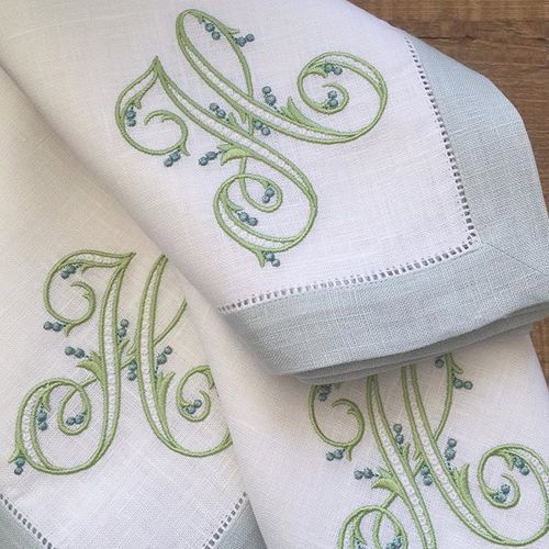 A close up of a napkin with a monogram on it