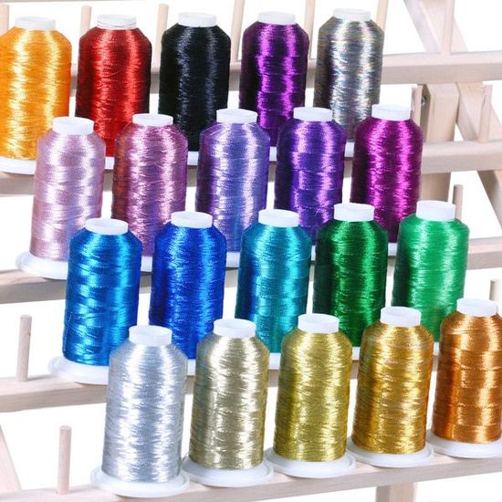 A bunch of different colored spools of thread on a shelf