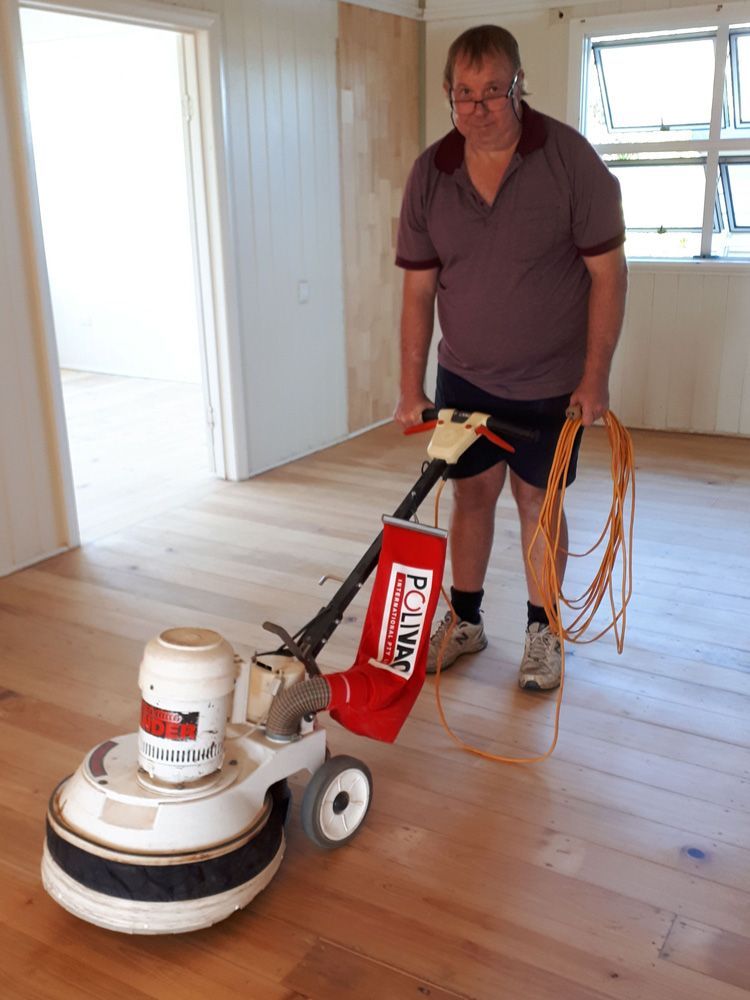 Man Cleans The Floor With A Polishing Machine — Flooring In Sharon, QLD