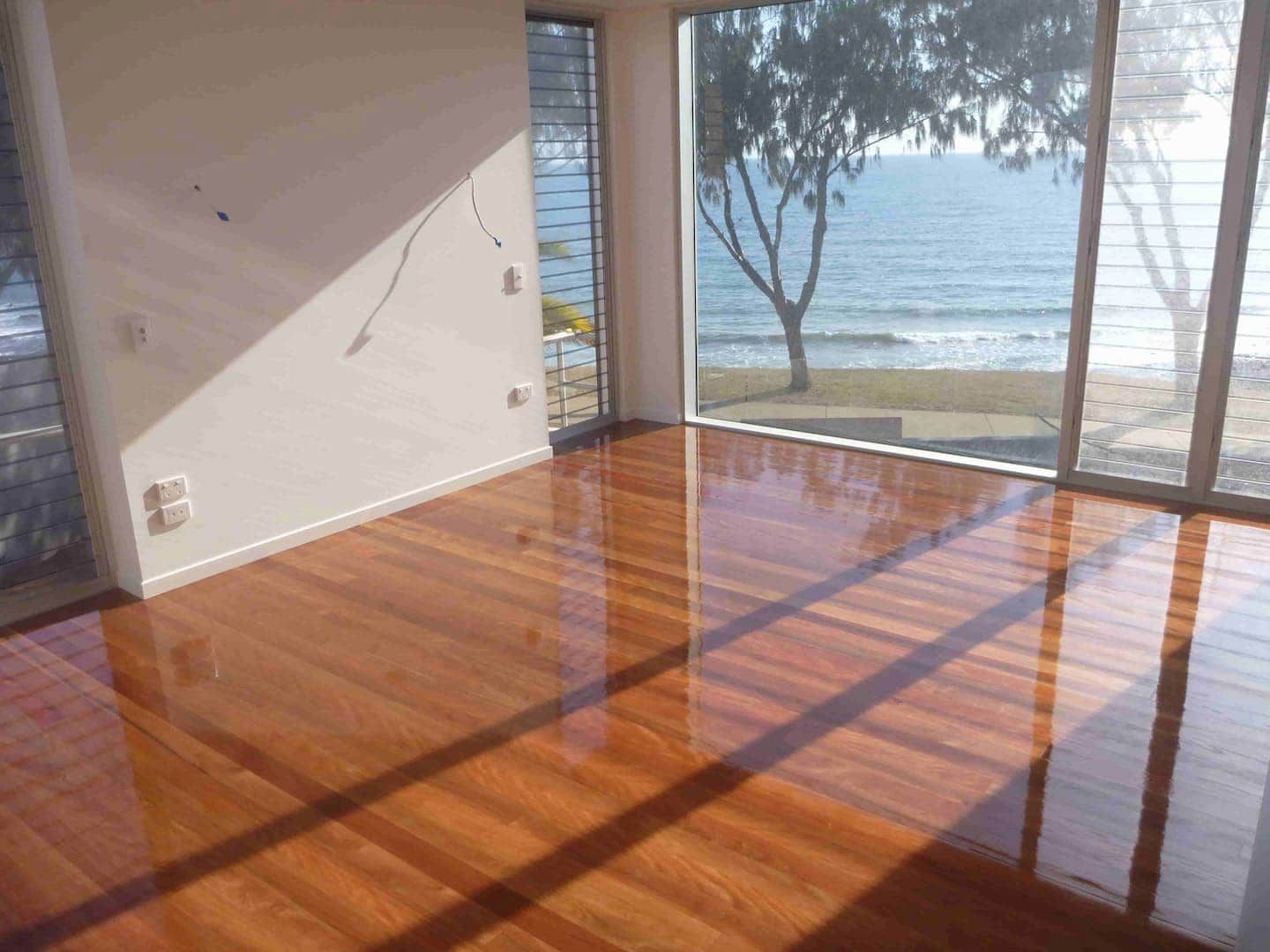 Clear brown timber flooring with sunlight — Flooring In Sharon, QLD