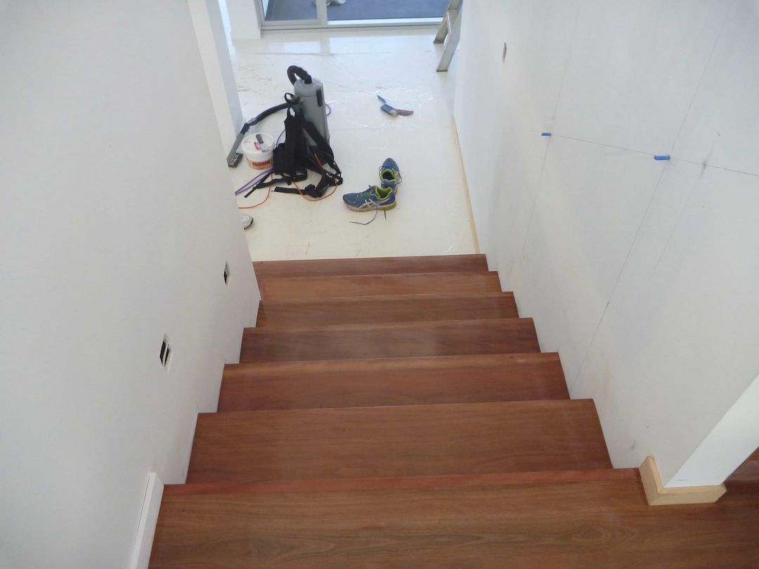 Solid timber staircase and white floor with equipment — Flooring In Sharon, QLD