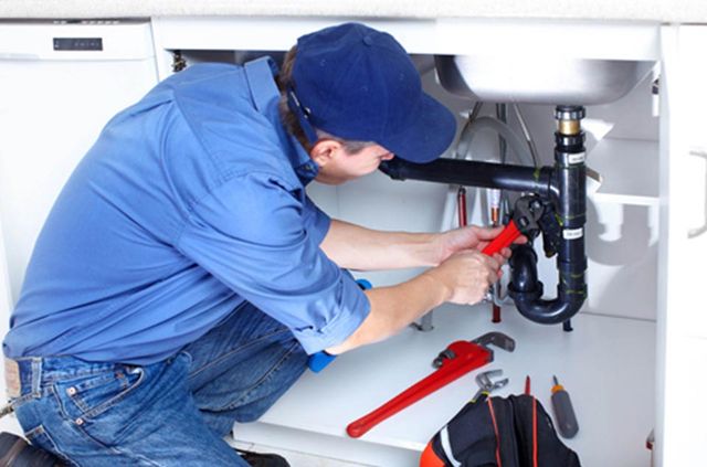 Man Fixing Pipe of The Sink — plumbing services in Port Charlotte, FL